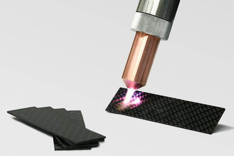 Relyon Plasma PB3 plasma jet directed onto a carbon fiber reinforced plastic sample
