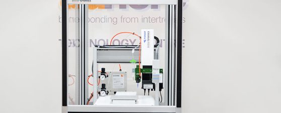 Automated dispensing and UV light curing system