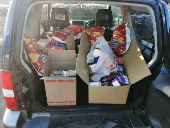 The boot of a colleague's vehicle filled with food bank donations
